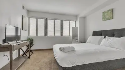 a bedroom with a bed and a desk and a television at PP 2114 Professional 2br apt, Near Hospitals in Harrisburg