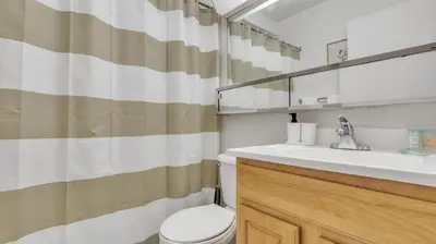 a bathroom with a sink and a toilet and a mirror at PP 2114 Professional 2br apt, Near Hospitals in Harrisburg