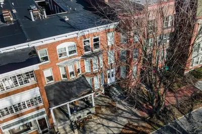 an overhead view of a brick building with a tree at Flats on Front - Riverfront Gem Fast Wi-Fi 3F in Harrisburg