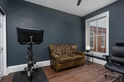 a living room with a chair and a television at Flats on Front - Riverfront Gem Fast Wi-Fi 3F in Harrisburg