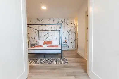 a bedroom with a bed and a wall with birds on it at Rosy Retreat with NYC Views by the train, Free Parking, 3 beds, 20 Percent OFF 7 days in Newark
