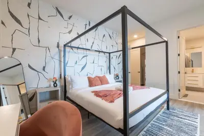 a bedroom with a bed and a wall with birds at Rosy Retreat with NYC Views by the train, Free Parking, 3 beds, 20 Percent OFF 7 days in Newark