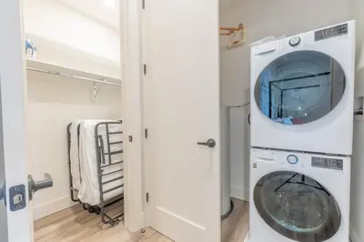 a laundry room with a washer and dryer at Rosy Retreat with NYC Views by the train, Free Parking, 3 beds, 20 Percent OFF 7 days in Newark