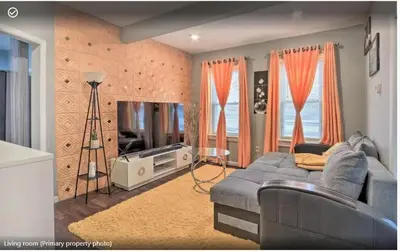 a living room with a blue couch and a television at Luxury Home in Linden