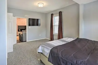 a bedroom with a bed and a living room at Luxury Home in Linden