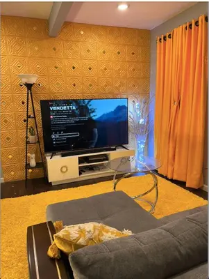 a living room with a tv and a glass table at Luxury Home in Linden