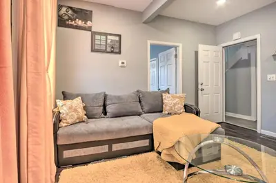 a living room with a gray couch and a glass table at Luxury Home in Linden