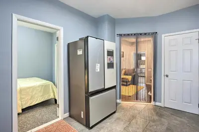 a large refrigerator in a room with a bedroom at Luxury Home in Linden