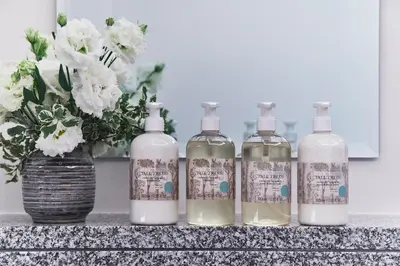 a group of four bottles of soap on a counter at Warren Street Hotel in New York