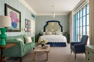 a bedroom with a bed and a couch and a chair at Warren Street Hotel in New York
