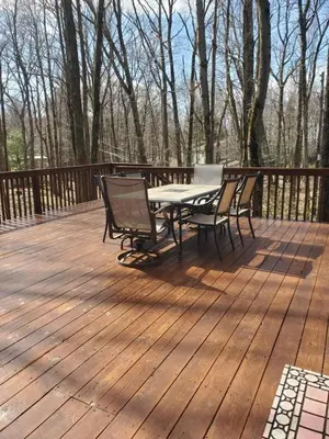 a picnic table and chairs on a wooden deck at Harmony in the Woods in Lake Harmony