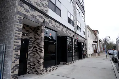 a brick building with large windows on a street at The Modern Suite - 2BR Close to NYC in Paterson