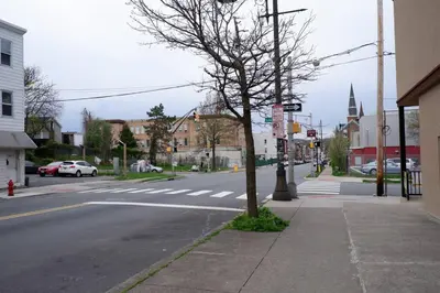 a tree on the side of a city street at The Cozy Suite - 1BR with Free Parking in Paterson