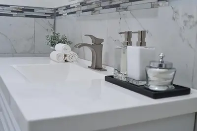 a kitchen counter with a sink with a mixer and towels at Beautiful Irving two bedroom apartment in Philadelphia