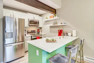 a kitchen with white cabinets and a refrigerator at Cozy Cabin with Deck Less Than 1 Mi to Jack Frost Resort! in White Haven