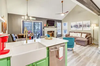 a kitchen with a sink and a living room at Cozy Cabin with Deck Less Than 1 Mi to Jack Frost Resort! in White Haven