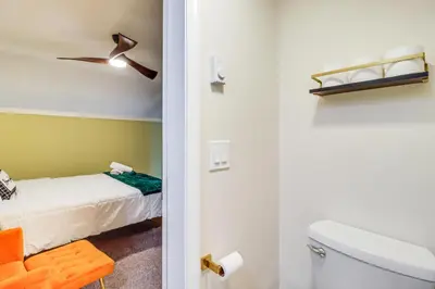 a bathroom with a bed and a toilet in a room at Cozy Cabin with Deck Less Than 1 Mi to Jack Frost Resort! in White Haven