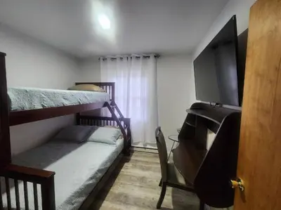 a room with two bunk beds and a tv at Poconos Retreat in Bushkill