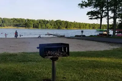 a blue box sitting in the grass next to a beach at Poconos Retreat in Bushkill