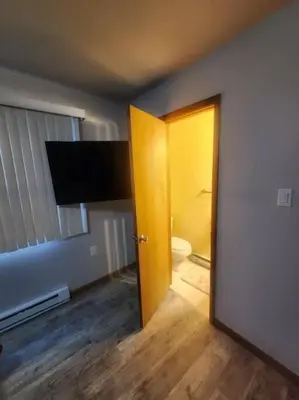 a room with a bathroom with a toilet and a door at Poconos Retreat in Bushkill