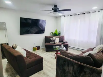 a living room with two couches and a ceiling fan at Poconos Retreat in Bushkill