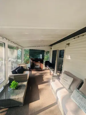 a living room with couches and a flat screen tv at Poconos Retreat in Bushkill
