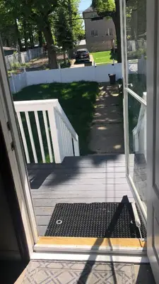 an open door to a porch with a gate at room with a private shower in Arlington