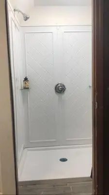 a shower with a glass door in a bathroom at room with a private shower in Arlington