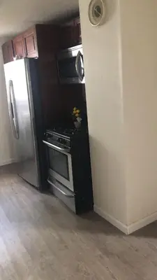 a kitchen with a stove and a refrigerator at room with a private shower in Arlington