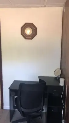a desk with a chair and a light on a wall at room with a private shower in Arlington