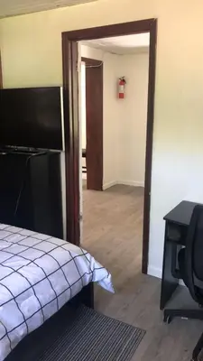 a bedroom with a door open to a room at room with a private shower in Arlington