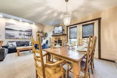 a dining room with a table and a fireplace at Community Beach Access Lake Harmony Townhome in Lake Harmony