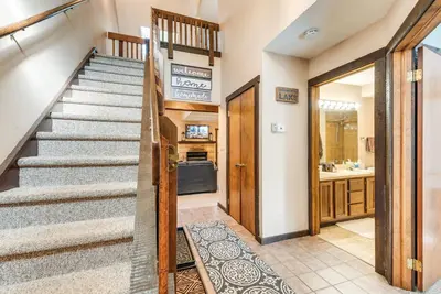 a staircase in a home with aoyer with a stair case at Community Beach Access Lake Harmony Townhome in Lake Harmony