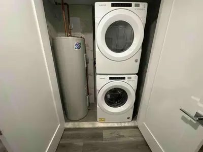 a washing machine and a washer in a small room at The Comfy Suite - 1BR with Free Parking in Paterson
