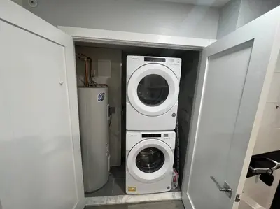 a washer and dryer in a small room at The Lovely Suite - 1BR close to NYC in Paterson