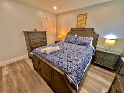 a bedroom with a large bed and two night stands at The Classy Suite - 2BR with Free Parking in Paterson