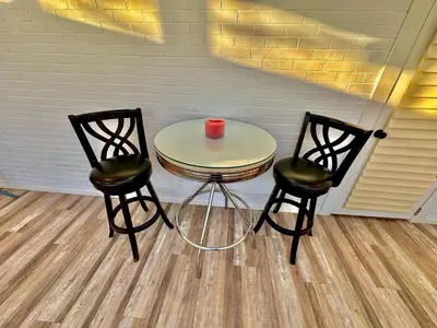 a table and two chairs with a red candle on it at Ultimate Luxury Villa - Pool, Sauna, Hot Tub & More in Paterson