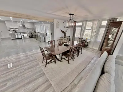 a dining room with a table and chairs and a couch at Ultimate Luxury Villa - Pool, Sauna, Hot Tub & More in Paterson