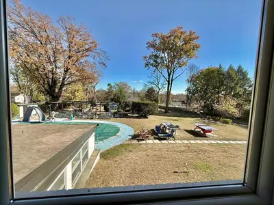 a view of a swimming pool from a window at Ultimate Luxury Villa - Pool, Sauna, Hot Tub & More in Paterson