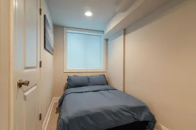 a small bedroom with a bed and a window at Roof Deck Oasis near PENN and CHOP in Philadelphia