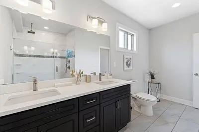 a white bathroom with a sink and a toilet at Roof Deck Oasis near PENN and CHOP in Philadelphia