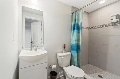 a bathroom with a toilet and a sink and a shower at Roof Deck Oasis near PENN and CHOP in Philadelphia