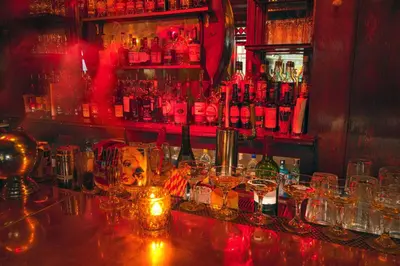 a bar with a bunch of glasses on a counter at Hotel Edison Times Square in New York