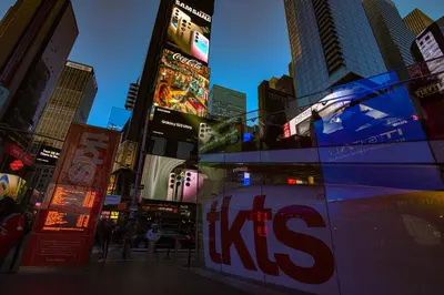 a city street with tall buildings and a kiss sign at Hotel Edison Times Square in New York