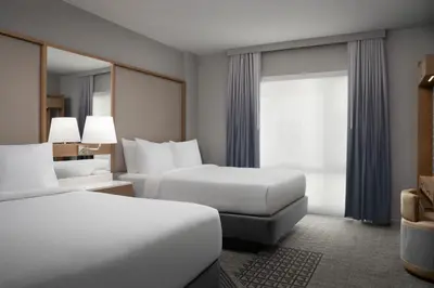 a hotel room with two beds and a window at SpringHill Suites by Marriott New York Manhattan Times Square in New York