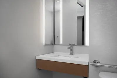 a bathroom with a sink and a mirror at SpringHill Suites by Marriott New York Manhattan Times Square in New York
