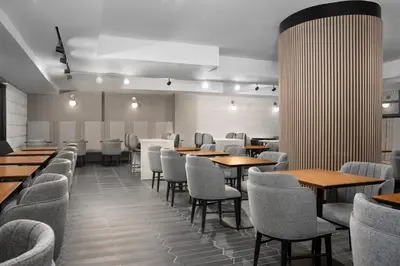 a dining room with tables and chairs and tablesktop at SpringHill Suites by Marriott New York Manhattan Times Square in New York
