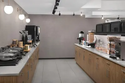 a kitchen with a long counter in a kitchen at SpringHill Suites by Marriott New York Manhattan Times Square in New York