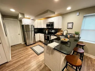 a kitchen with a refrigerator and a counter top at Boardwalk- large modern unit with King bed fast WIFI free coffee and easy parking in Wilmington