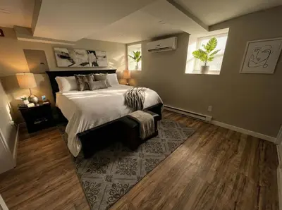a bedroom with a large bed and a window at Boardwalk- large modern unit with King bed fast WIFI free coffee and easy parking in Wilmington